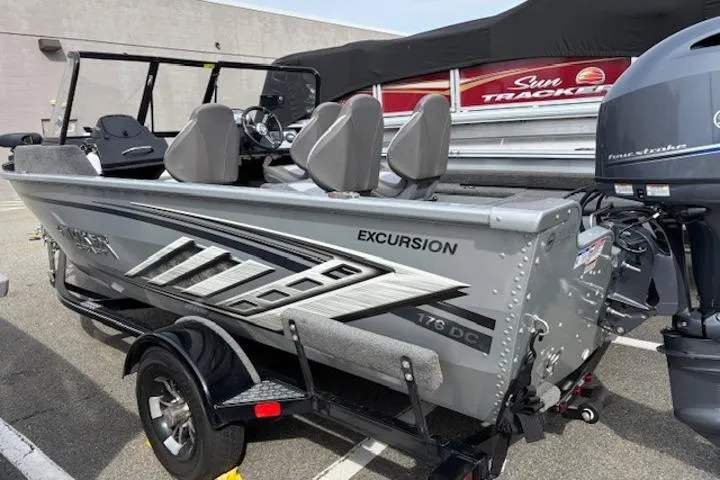 Slide: The Image of 2023 Smoker Craft Excursion 176 DC boat on trailer, side view. - 0