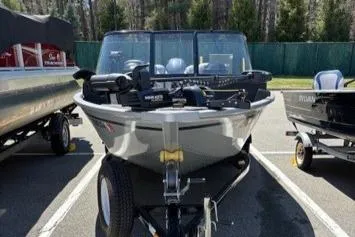 Slide: The Image of 2023 Smoker Craft Excursion 176 DC boat on trailer in parking lot. - 10