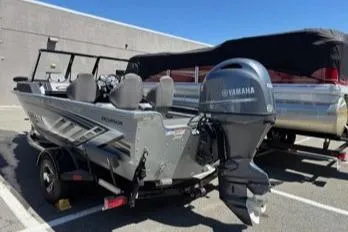 Slide: The Image of 2023 Smoker Craft Excursion 176 DC boat with Yamaha outboard motor in parking lot. - 11