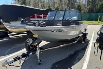 Slide: The Image of 2023 Smoker Craft Excursion 176 DC boat on trailer in parking lot. - 13