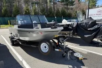 Slide: The Image of 2023 Smoker Craft Excursion 176 DC boat on trailer in parking lot. - 14