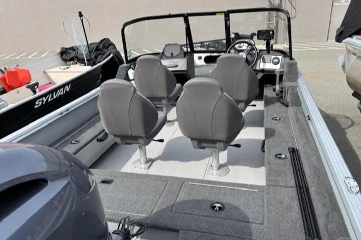 Slide: The Image of 2023 Smoker Craft Excursion 176 DC boat interior with four gray seats and steering console. - 15