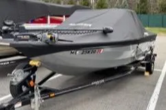 Slide: The Image of 2023 Smoker Craft Excursion 176 DC boat on trailer, covered and parked outdoors. - 17
