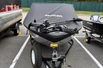 Slide: The Image of 2023 Smoker Craft Excursion 176 DC boat on trailer, covered and parked outdoors. - 18