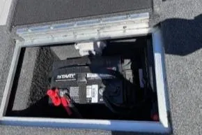 Slide: The Image of 2023 Smoker Craft Excursion 176 DC boat battery compartment with visible wiring. - 19