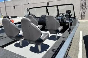 Slide: The Image of 2023 Smoker Craft Excursion 176 DC interior with four gray seats and steering console. - 2