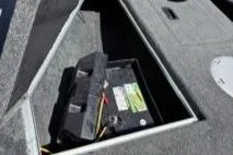 Slide: The Image of 2023 Smoker Craft Excursion 176 DC boat battery compartment with visible wiring. - 21