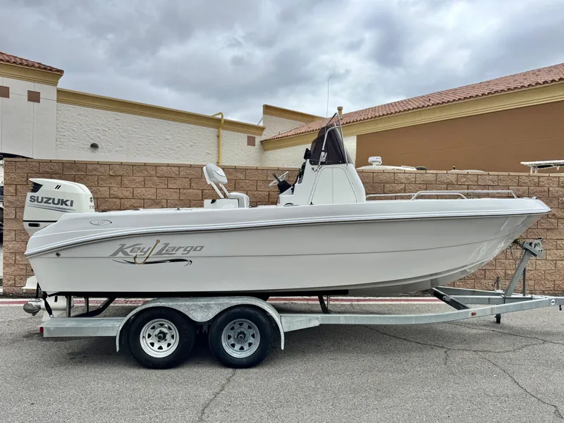 The Image of 2019 Caravelle Key Largo 2100 boat on trailer, parked outdoors, featuring Suzuki engine. - 0