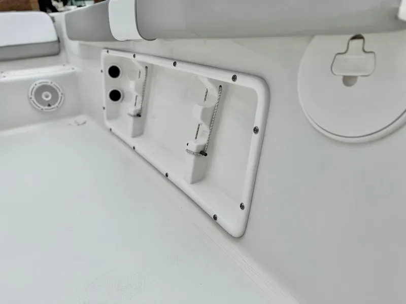 Slide: The Image of 2019 Caravelle Key Largo 2100 boat interior, featuring storage compartments and seating area. - 13