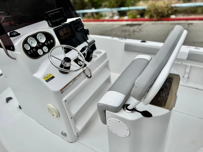 Slide: The Image of 2019 Caravelle Key Largo 2100 boat cockpit with steering wheel and control panel. - 15