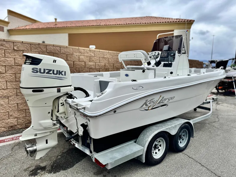 Slide: The Image of 2019 Caravelle Key Largo 2100 boat with Suzuki outboard motor on a trailer. - 5