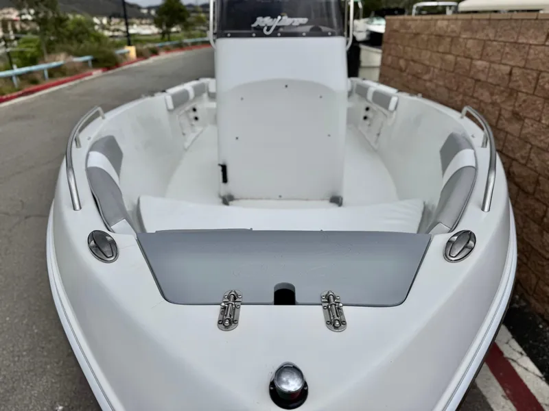 Slide: The Image of 2019 Caravelle Key Largo 2100 boat, white interior, docked outdoors. - 7