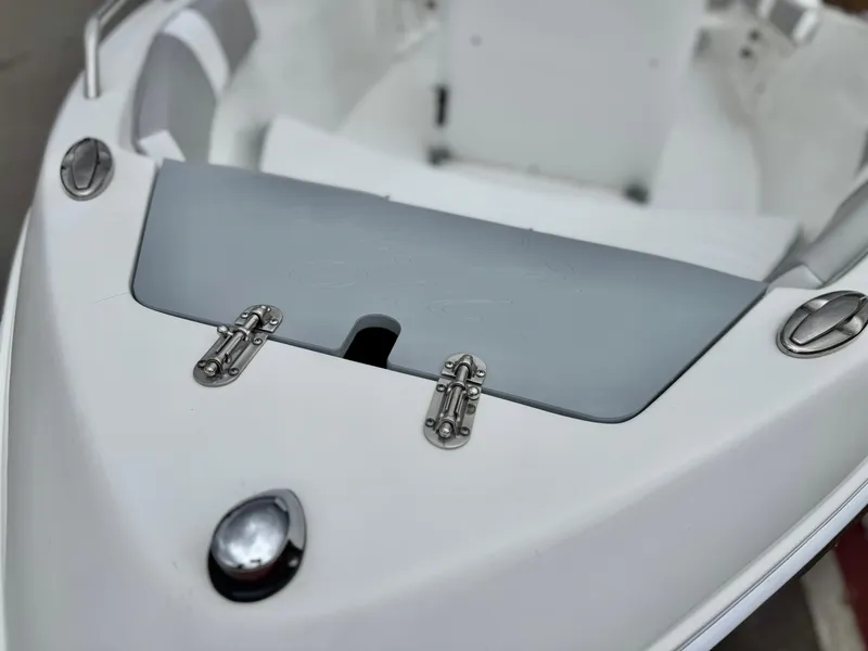 Slide: The Image of 2019 Caravelle Key Largo 2100 boat interior with sleek white design and stainless steel fittings. - 8