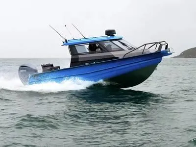 Slide: The Image of 2025 Stabicraft 2350 Supercab Sportfish boat navigating choppy waters. - 1