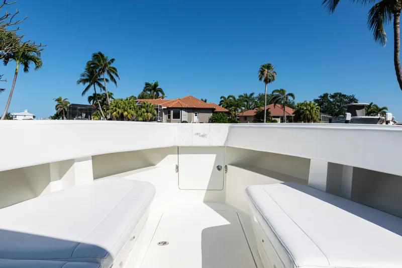 Slide: The Image of 2015 SeaVee 390Z boat interior with white seating, tropical background, and clear blue sky. - 13