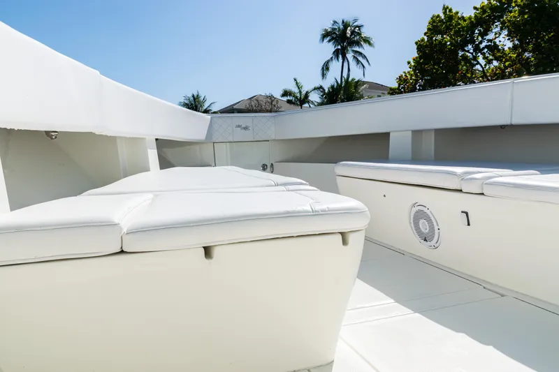 Slide: The Image of 2015 SeaVee 390Z boat interior with white seating, tropical background. - 14