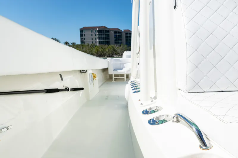 Slide: The Image of 2015 SeaVee 390Z boat interior with modern seating and controls, against a coastal backdrop. - 19