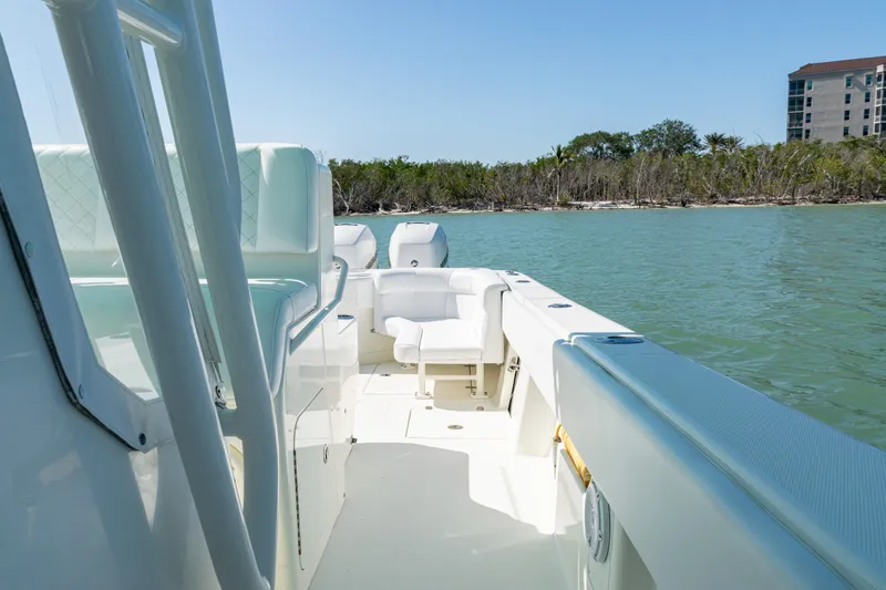 Slide: The Image of 2015 SeaVee 390Z boat on calm water, featuring spacious deck and seating. - 23