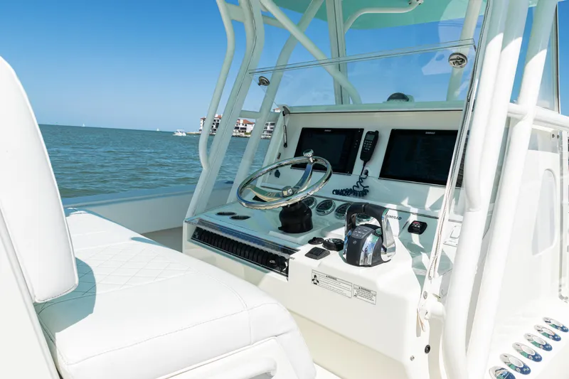 Slide: The Image of 2015 SeaVee 390Z boat cockpit with steering wheel and navigation screens. - 24