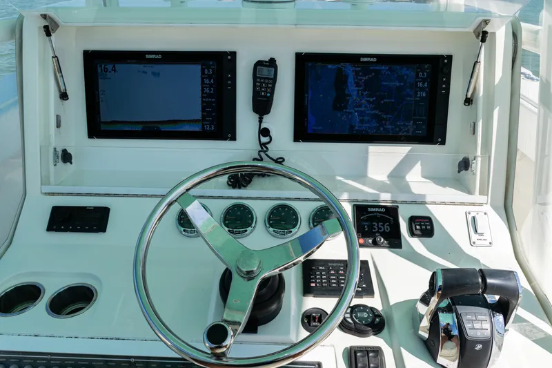 Slide: The Image of Control panel of a 2015 SeaVee 390Z boat with dual screens and steering wheel. - 26