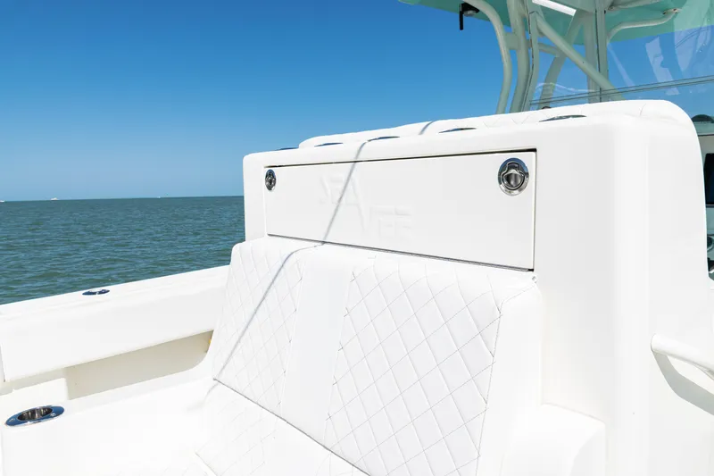 Slide: The Image of 2015 SeaVee 390Z boat with white seating, ocean backdrop, and clear blue sky. - 31