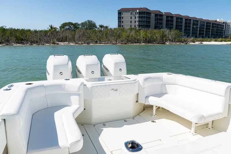 Slide: The Image of 2015 SeaVee 390Z boat with spacious seating, four engines, and scenic waterfront view. - 33