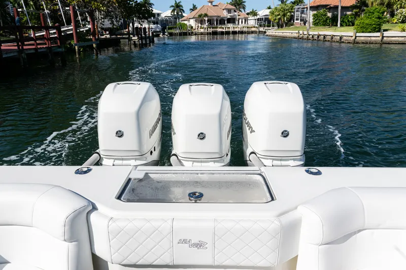 Slide: The Image of 2015 SeaVee 390Z boat with triple outboard engines on a calm waterway. - 36