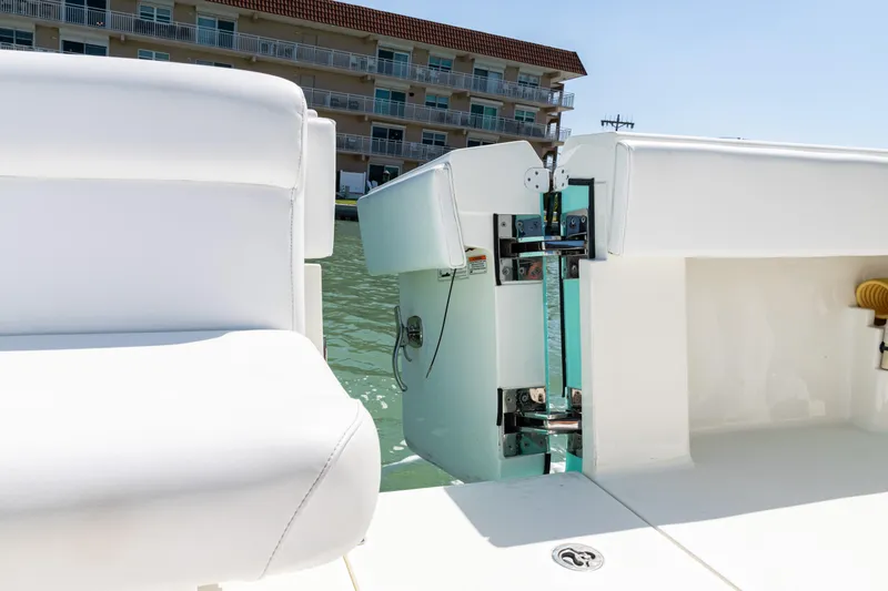 Slide: The Image of 2015 SeaVee 390Z boat with open transom door, docked near waterfront building. - 37