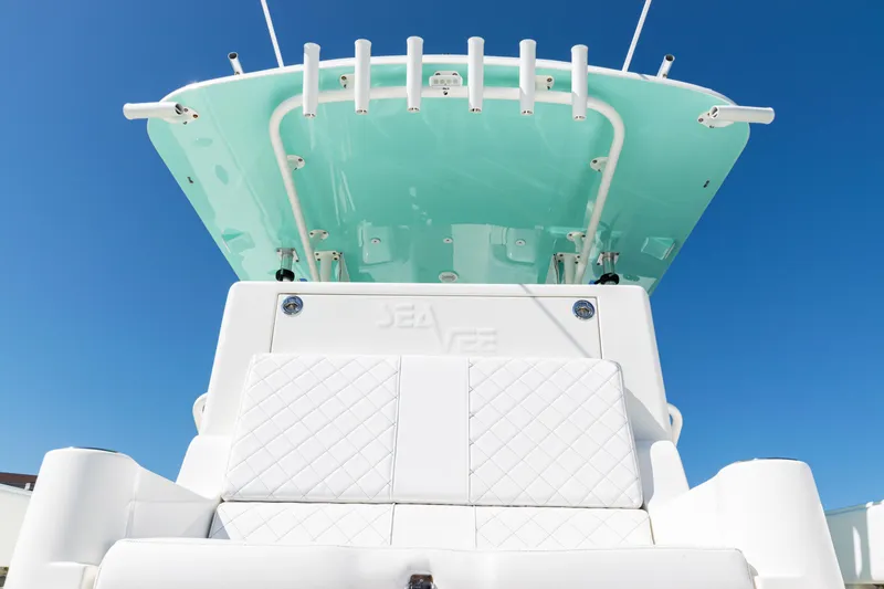 Slide: The Image of 2015 SeaVee 390Z boat, featuring a sleek design and spacious seating, under a clear blue sky. - 39