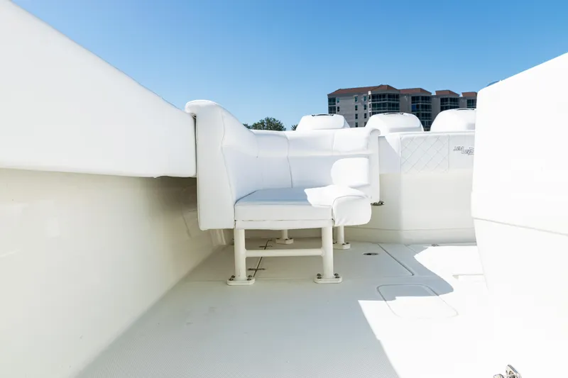 Slide: The Image of 2015 SeaVee 390Z boat interior with white seating and clear blue sky. - 40