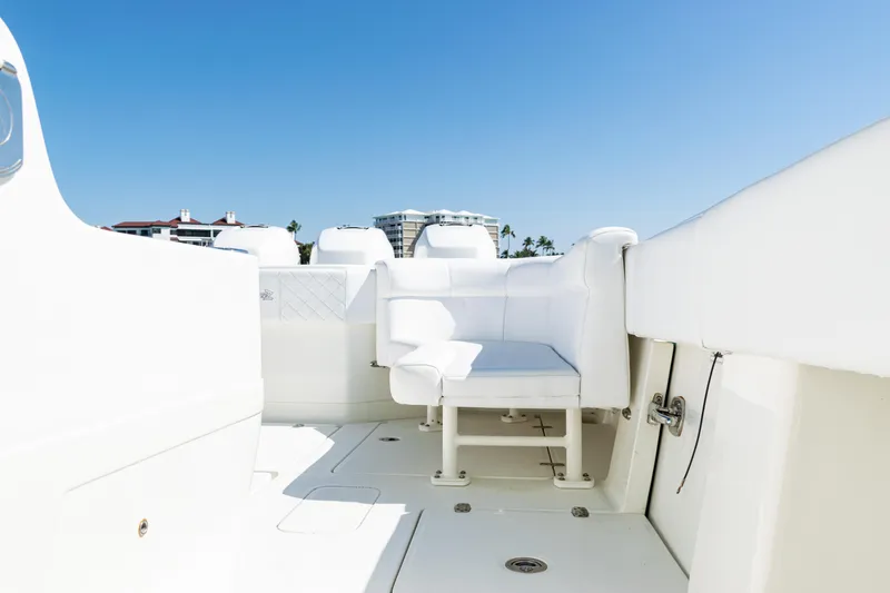 Slide: The Image of 2015 SeaVee 390Z boat interior with white seating and clear blue sky. - 41