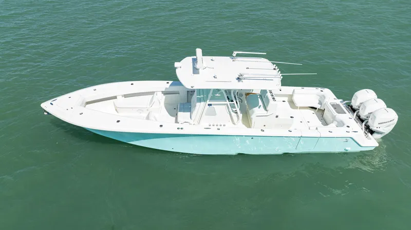 Slide: The Image of 2015 SeaVee 390Z boat on open water, featuring a sleek design and triple outboard engines. - 43