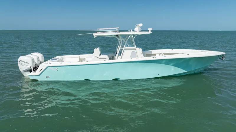 Slide: The Image of 2015 SeaVee 390Z boat on calm ocean waters under clear blue sky. - 44