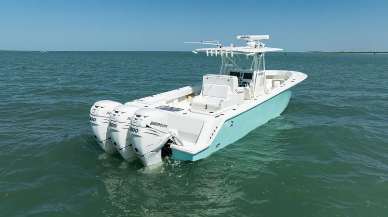 Slide: The Image of 2015 SeaVee 390Z boat with triple outboard engines on open water. - 45