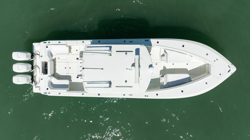 Slide: The Image of Aerial view of 2015 SeaVee 390Z boat on water with triple engines. - 47