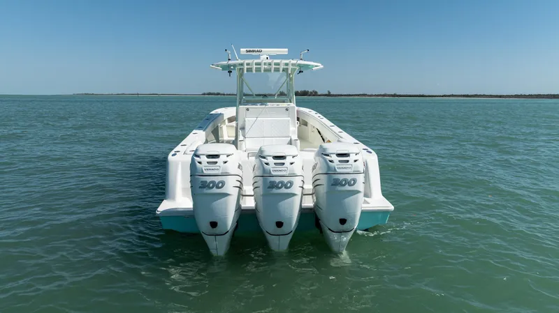 Slide: The Image of 2015 SeaVee 390Z boat with triple outboard engines on open water. - 5