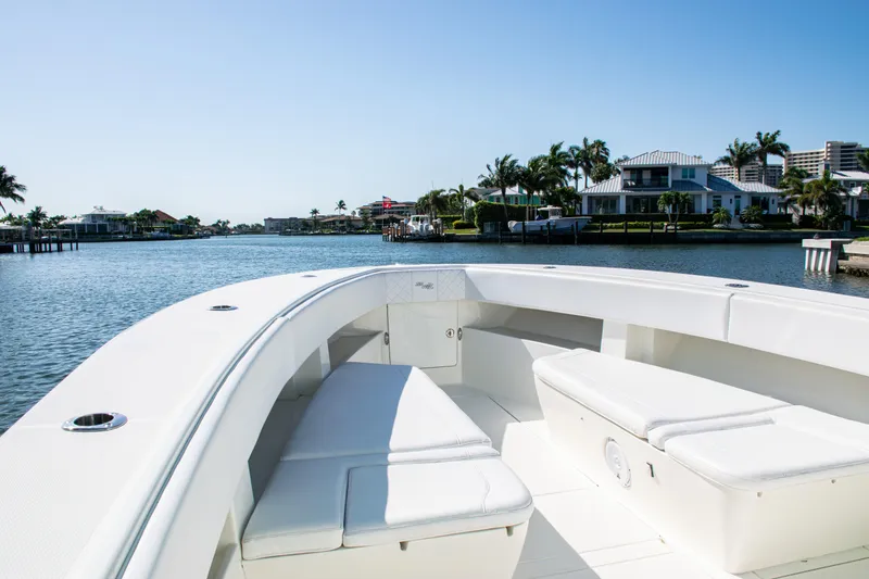 Slide: The Image of 2015 SeaVee 390Z boat with spacious seating, cruising on a sunny waterfront. - 8