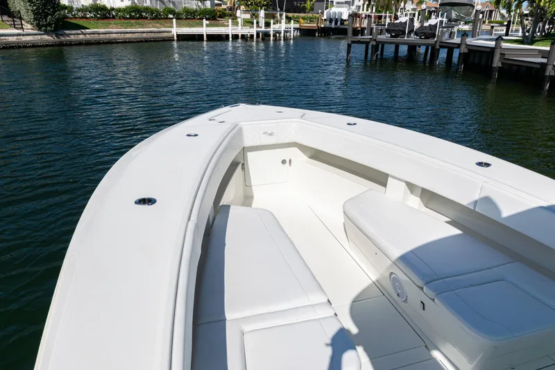 Slide: The Image of 2015 SeaVee 390Z boat bow with seating, docked in calm waters. - 9