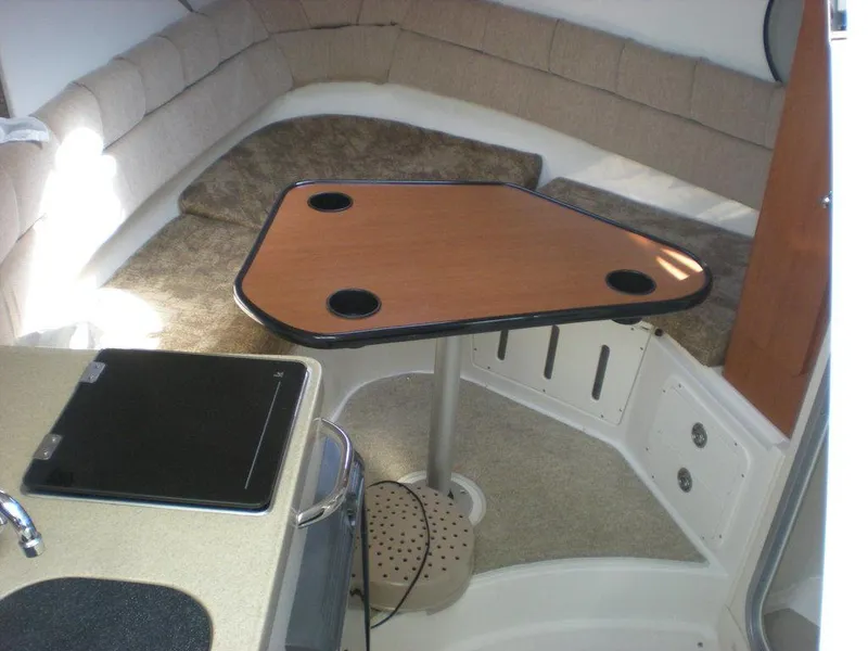 Slide: The Image of Interior of a 2006 Seaswirl Striper boat with table and seating area. - 13