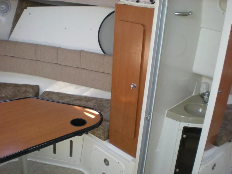 Slide: The Image of 2006 Seaswirl Striper cabin interior with table, seating, and compact sink area. - 14
