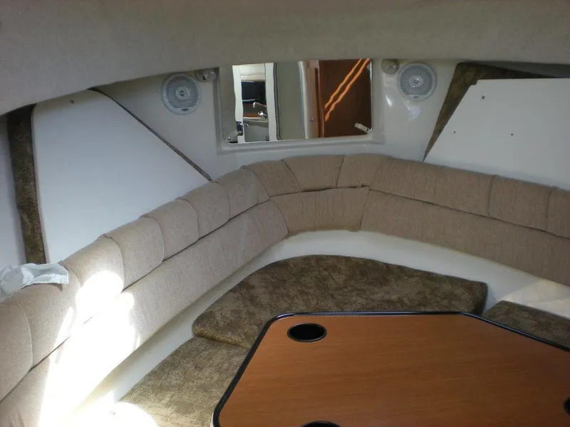 Slide: The Image of 2006 Seaswirl Striper interior with beige seating and wooden table. - 15