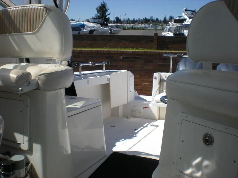 Slide: The Image of 2006 Seaswirl Striper boat interior with white seating and outdoor marina view. - 19