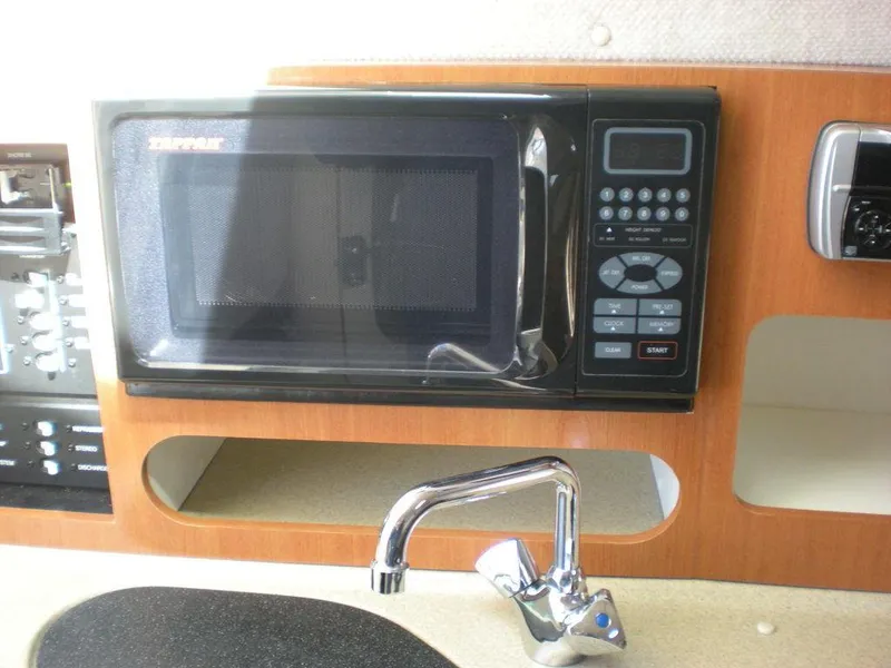 Slide: The Image of 2006 Seaswirl Striper boat interior with microwave and sink. - 20