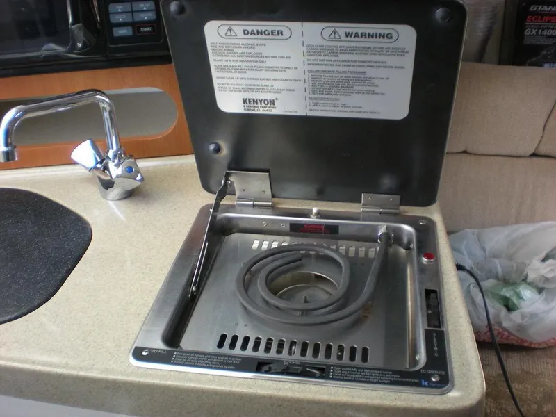 Slide: The Image of 2006 Seaswirl Striper boat kitchen with stove and sink. - 23