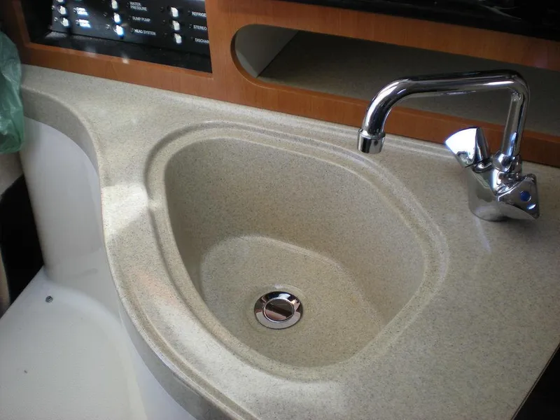 Slide: The Image of 2006 Seaswirl Striper boat sink with modern faucet and beige countertop. - 24