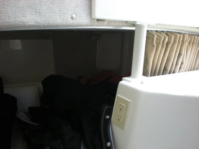 Slide: The Image of 2006 Seaswirl Striper cabin interior with electrical outlet and storage space. - 27