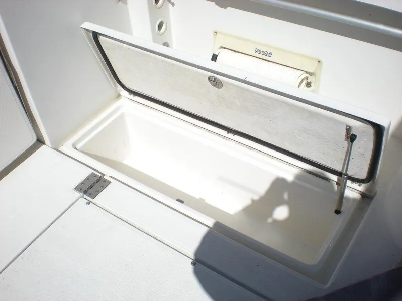 Slide: The Image of Open storage compartment on 2006 Seaswirl Striper boat, featuring a hinged lid. - 30