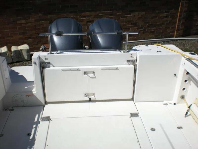 Slide: The Image of 2006 Seaswirl Striper boat deck with dual outboard motors and storage compartments. - 4