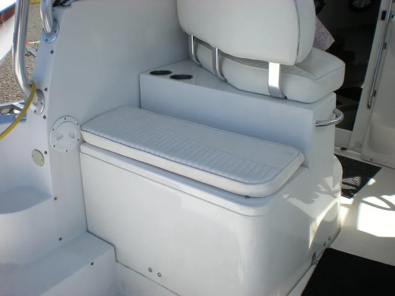 Slide: The Image of 2006 Seaswirl Striper boat interior with white seating and cup holders. - 5