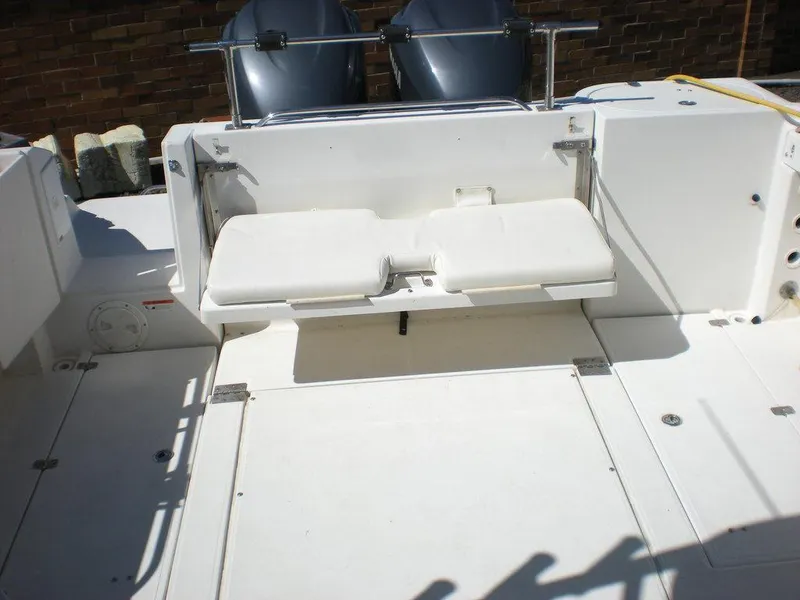 Slide: The Image of 2006 Seaswirl Striper boat deck with foldable seating and dual outboard motors. - 6